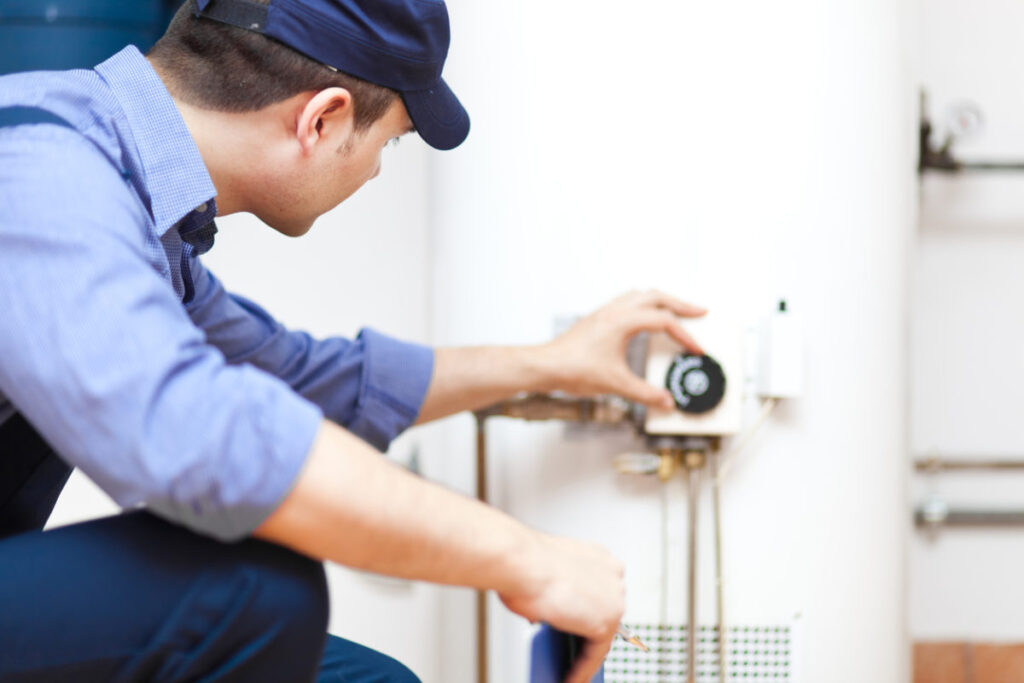 Technician inspecting a water heater