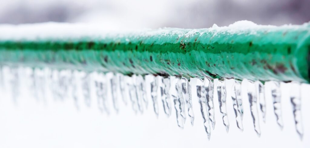 Frozen pipe with icicles hanging down