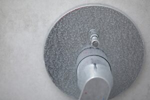 Limescale and soap scum on showerhead from hard water